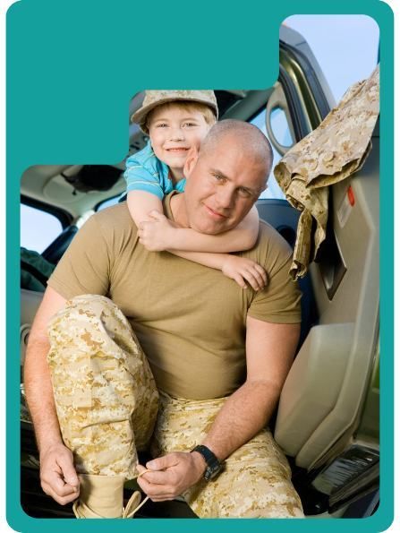 Soldier in uniform with child hugging him, both smiling. Inside a vehicle.