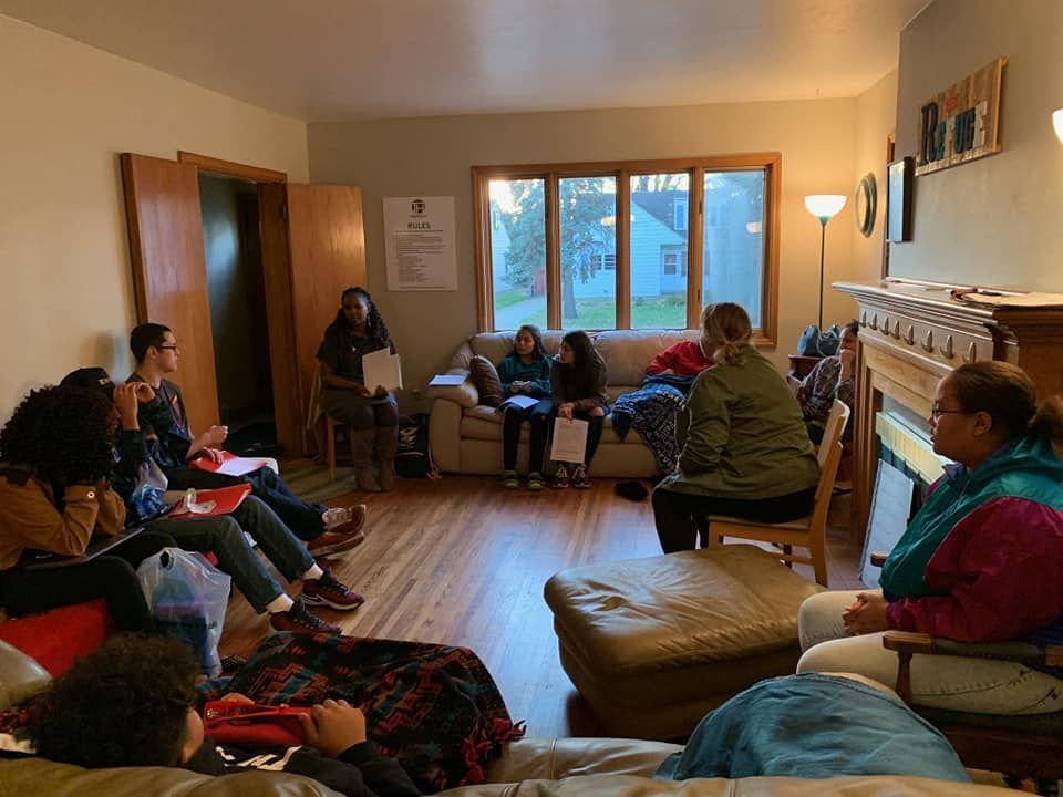 A group of people are sitting in a living room.
