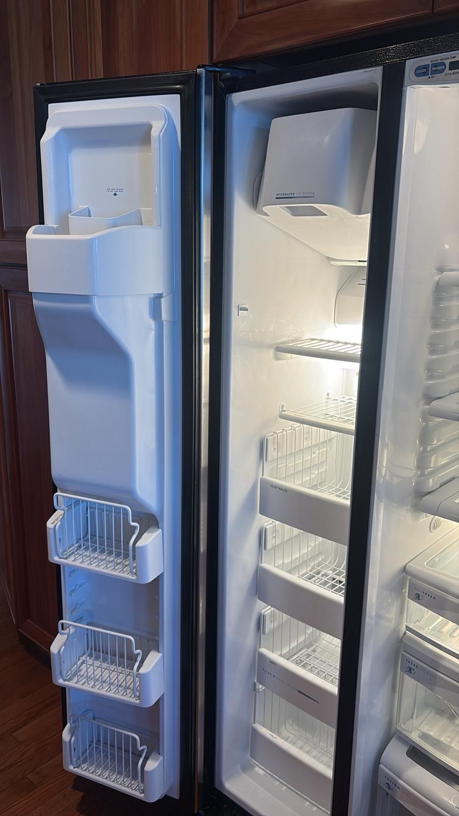 Open refrigerator showing the inside with shelves and door storage.