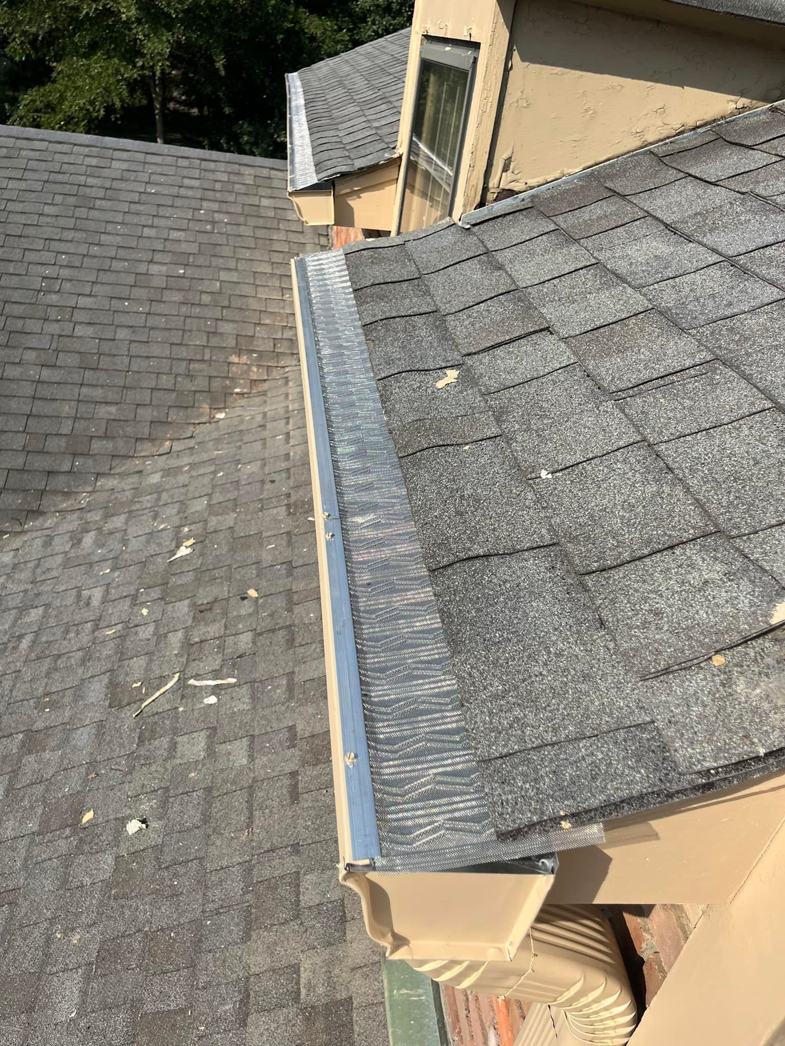 A close up of a gutter on a roof of a house.