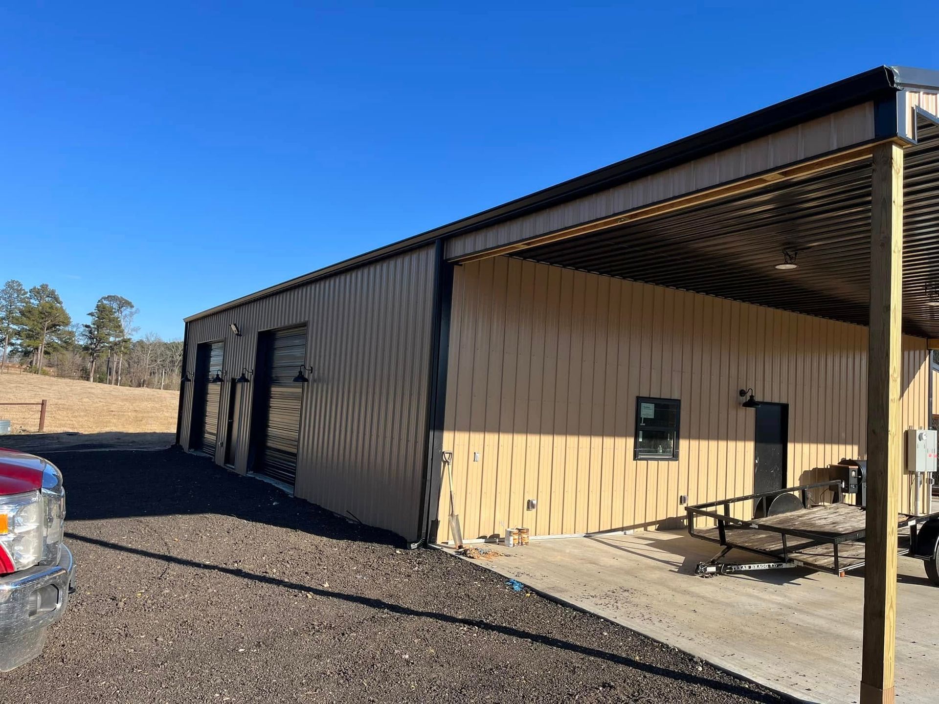 A truck is parked in front of a building with a covered patio.