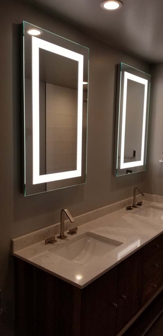 A bathroom with two sinks and two mirrors.