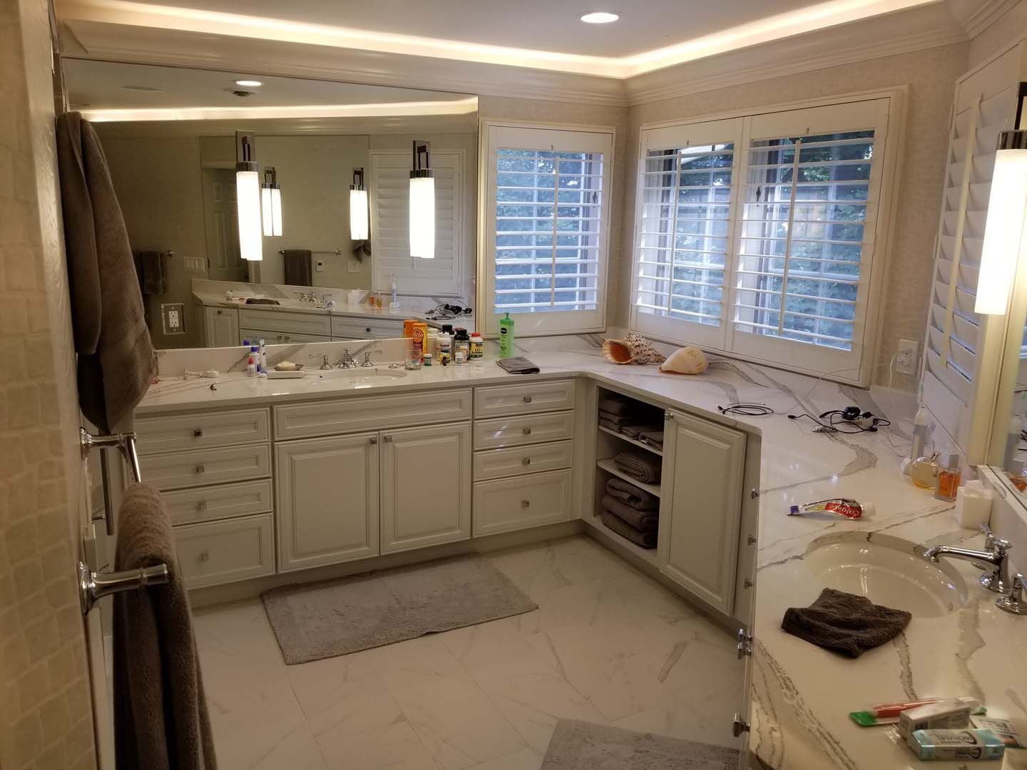 A bathroom with two sinks and a large mirror.