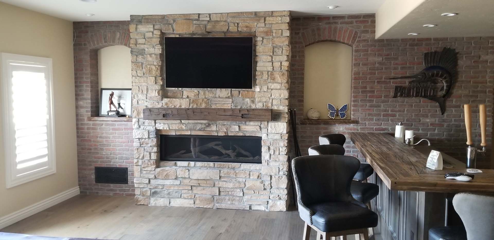 A living room with a fireplace and a flat screen tv