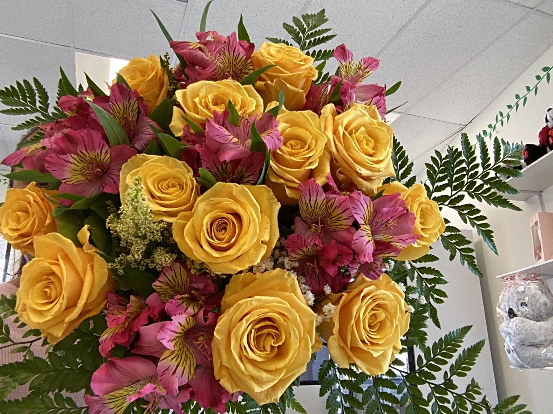 Yellow roses and pink flowers in a vase