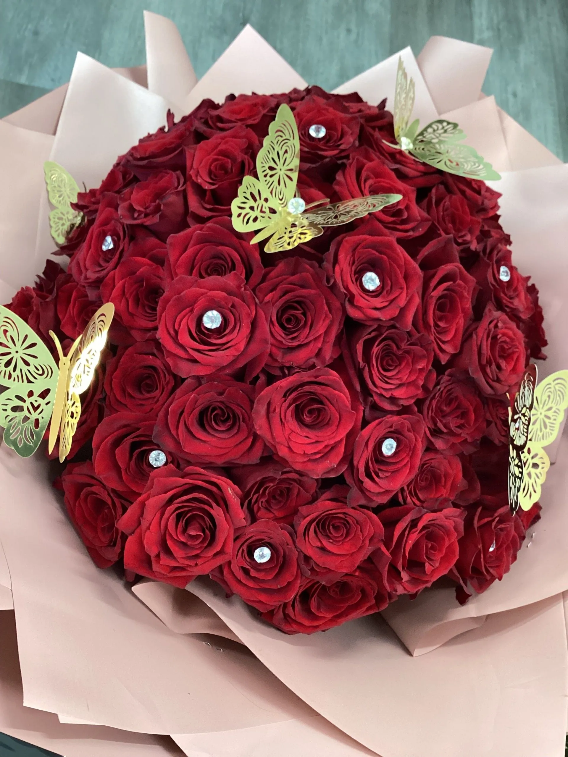 Bouquet of red roses with butterflies