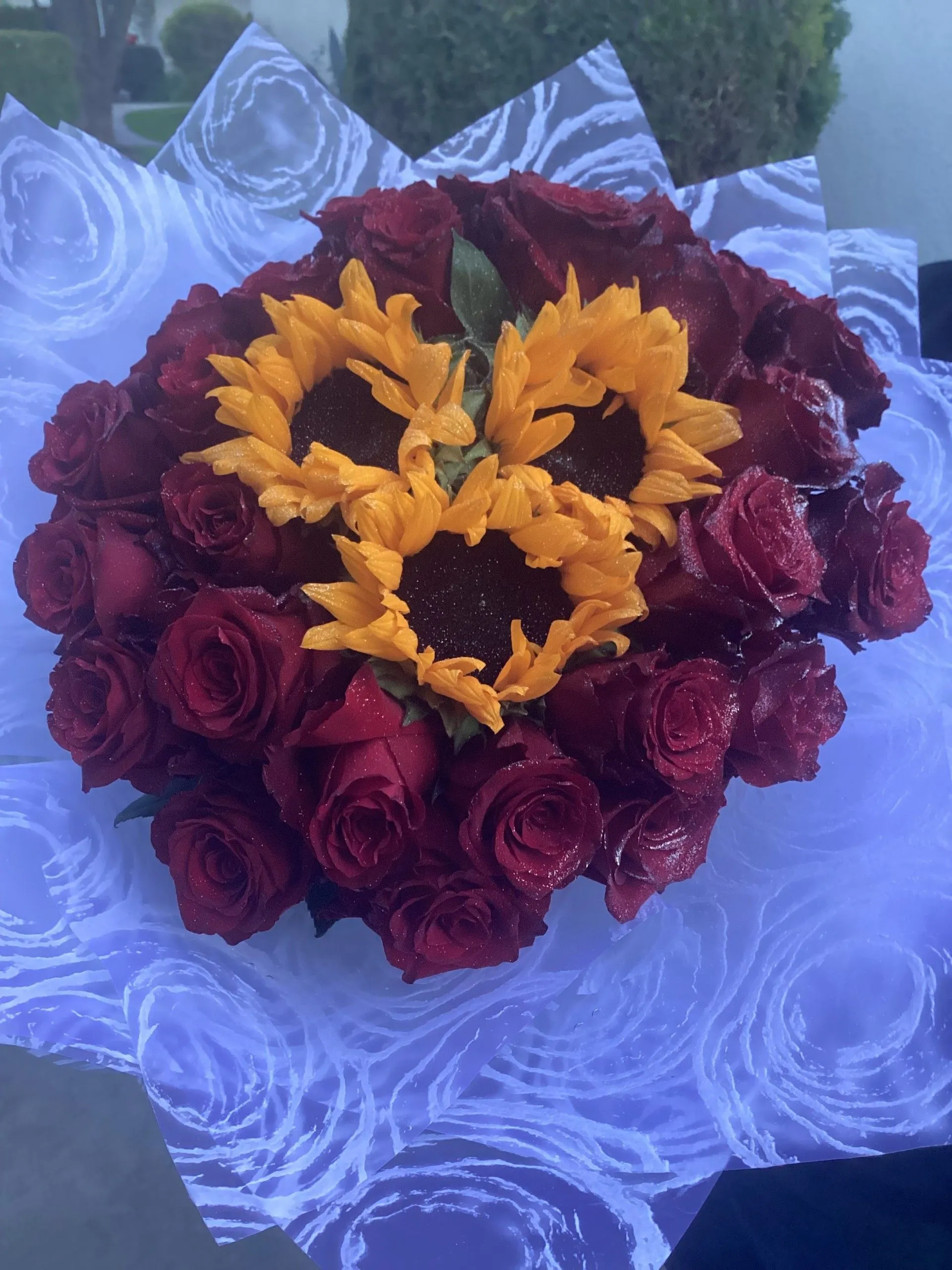 Bouquet of red roses with a sunflower