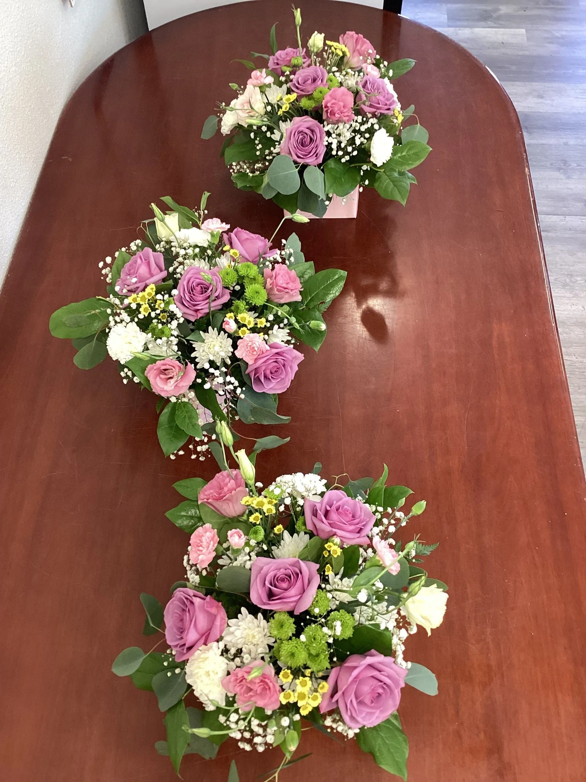 Three bouquets of pink and white flowers