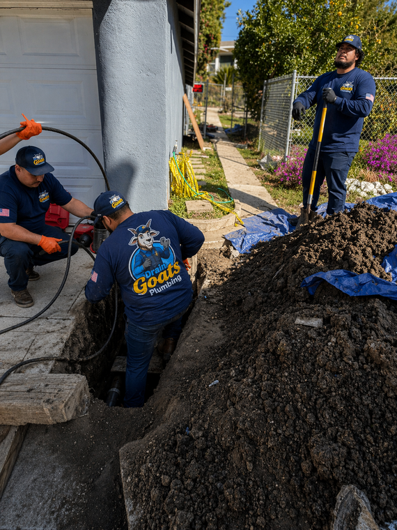 Manhole inspection: A technician uses a camera to examine a sewer system. Camera screen shows the inside of the pipe.