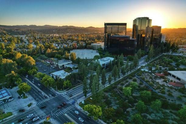 An aerial view of a city landscape with tall buildings at sunset.