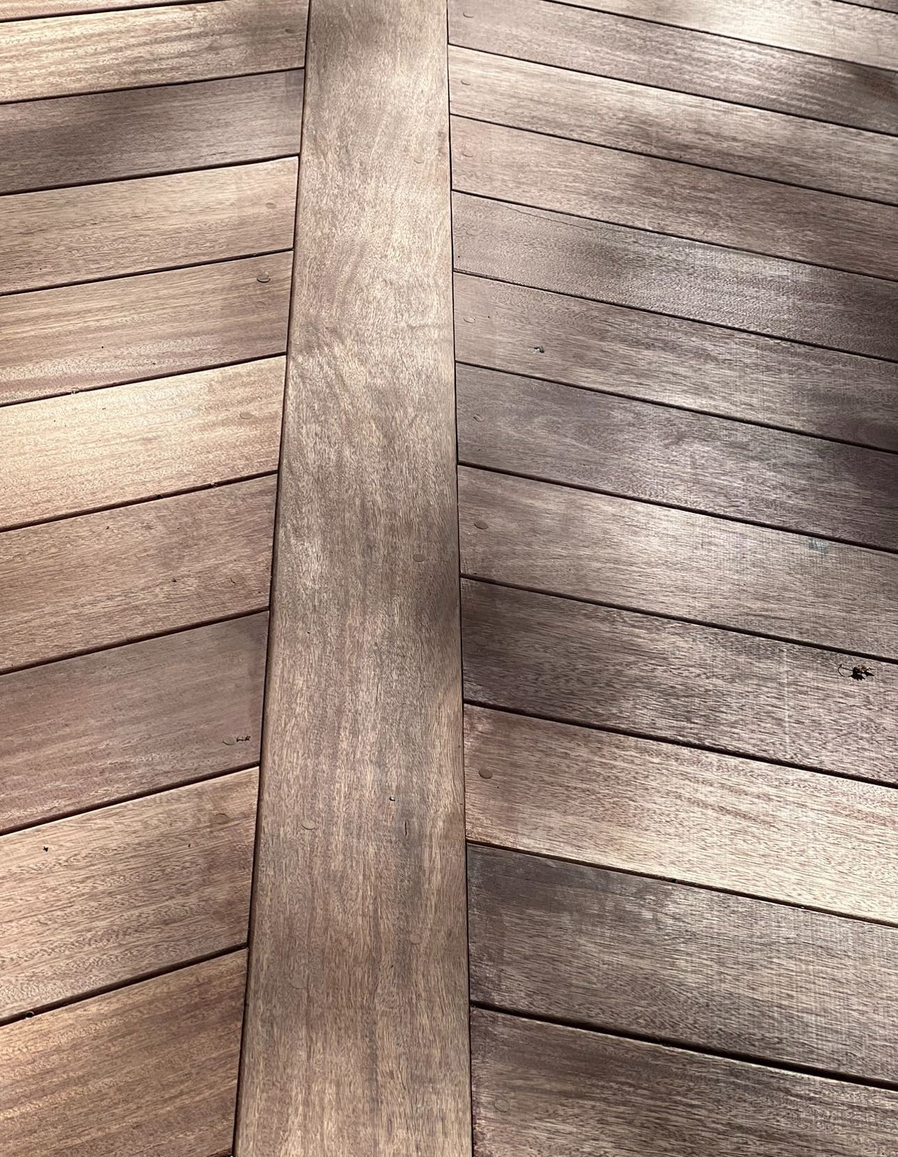 A close up of a piece of wood on a wooden deck.