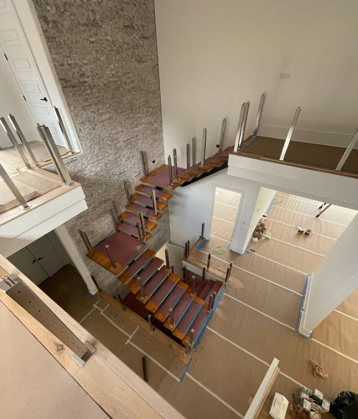 An aerial view of a wooden staircase in a house under construction.