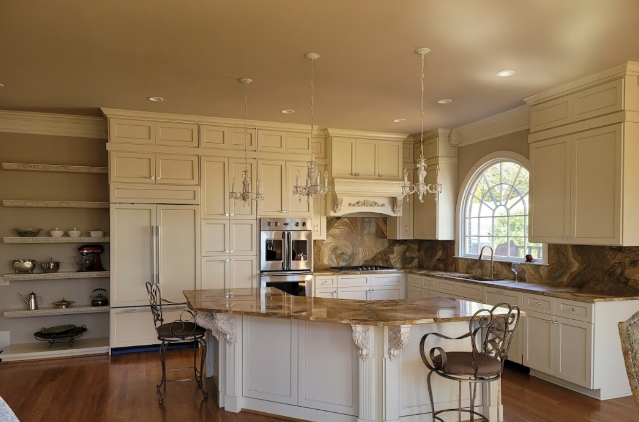 A kitchen with white cabinets and a large island