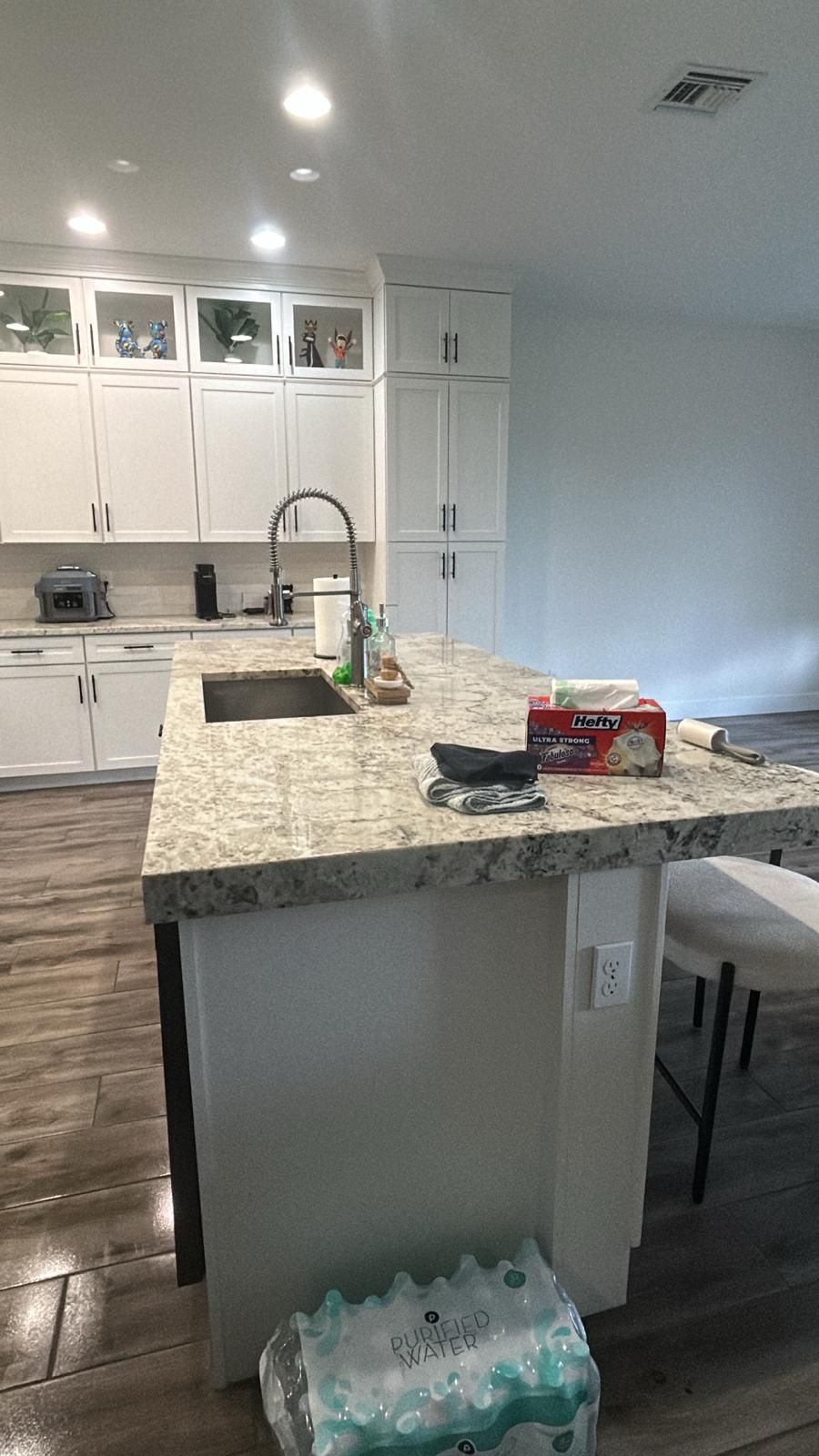 A kitchen with a large island and a sink.
