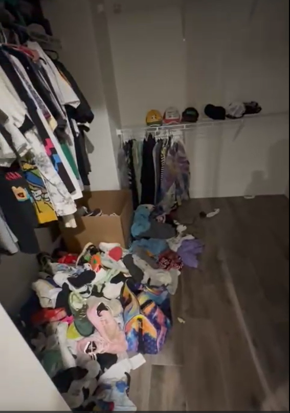 A messy closet filled with clothes and hats.