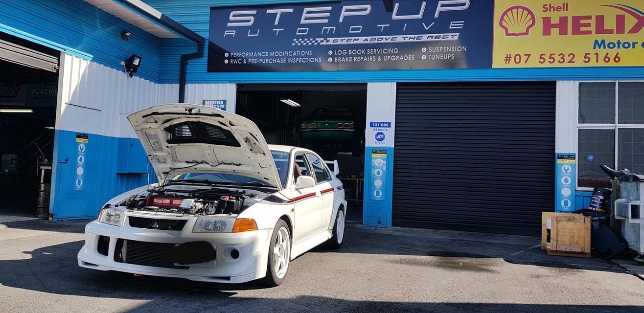 A White Car is Parked in Front of a Step Up Automotive Shop — Step Up Automotive in Southport, QLD