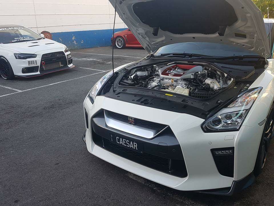 A White Sports Car With the Hood Open is Parked in a Parking Lot — Step Up Automotive in Southport, QLD