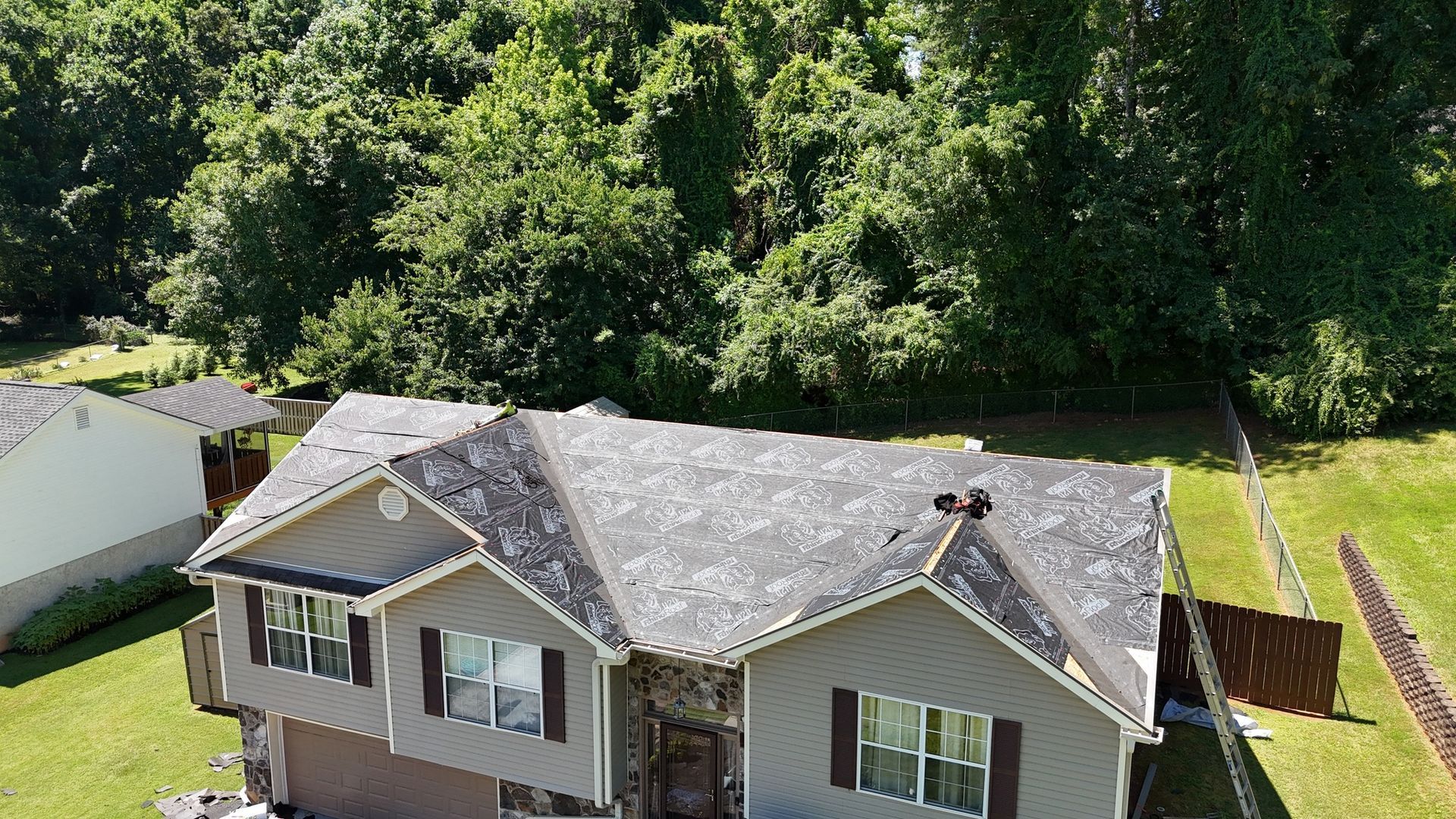 An aerial view of a house with a roof that is covered in shingles.