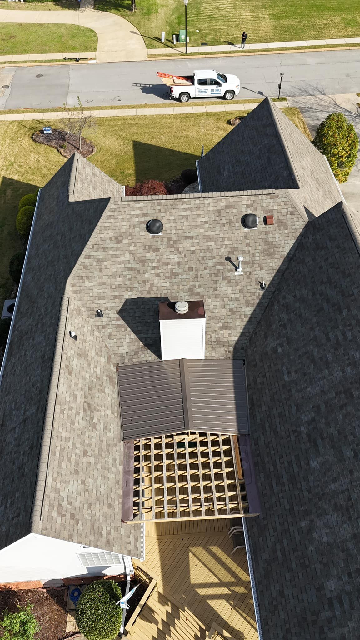 An aerial view of a house with a roof that is being built.