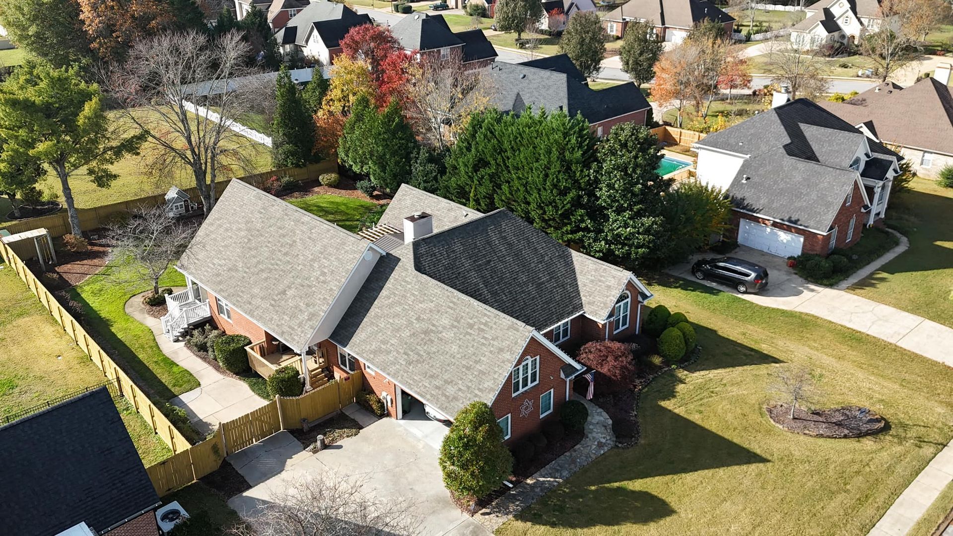 An aerial view of a residential area with houses and trees.