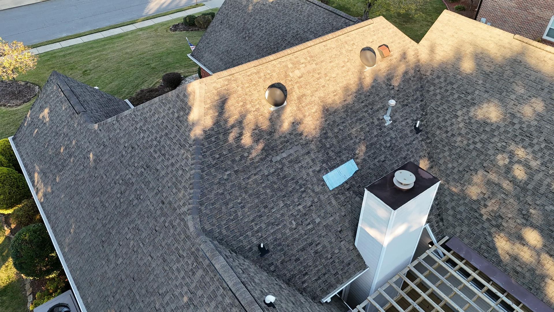 An aerial view of a roof of a house with a chimney.