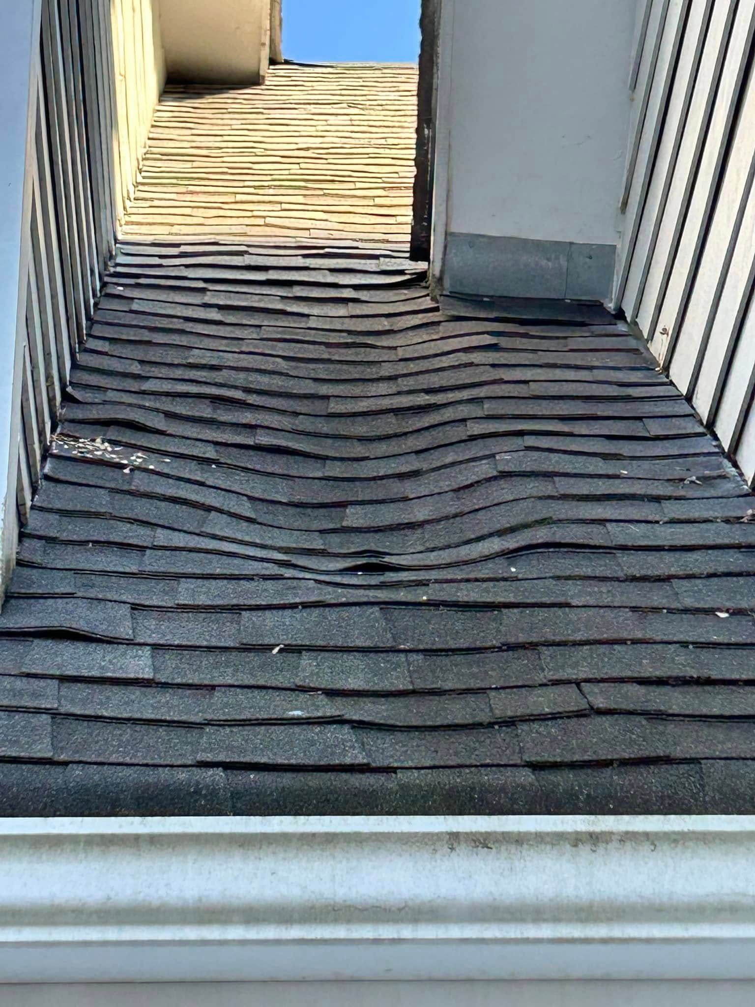 A close up of a roof with a gutter on it.