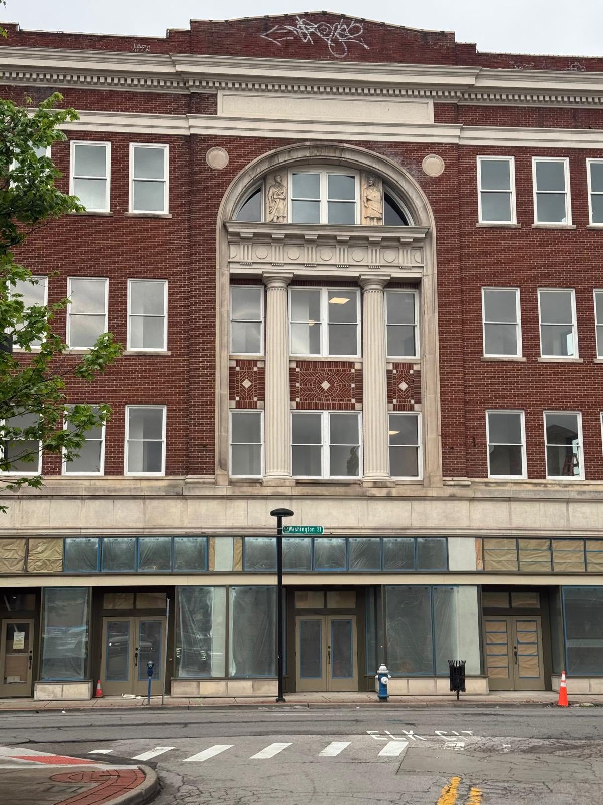 A large brick building with a fire hydrant in front of it