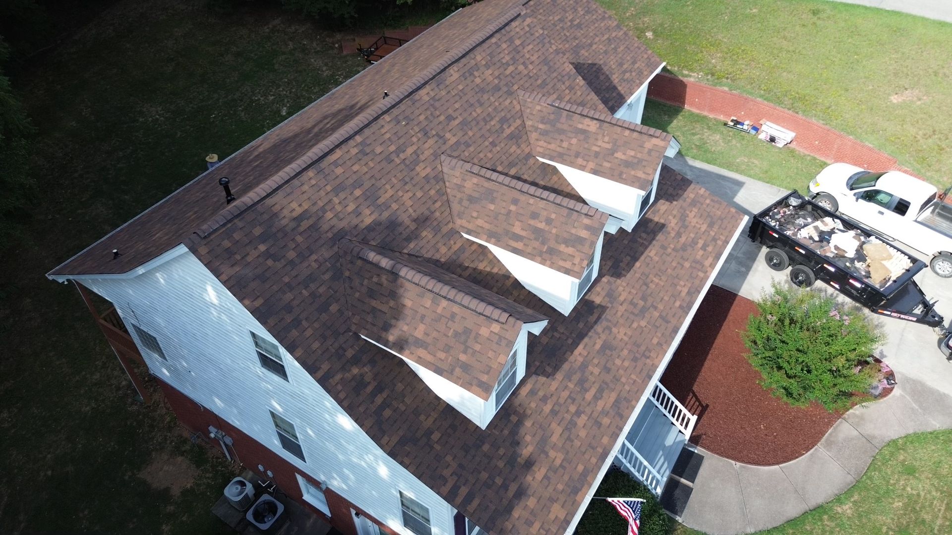 An aerial view of a house with a new roof.