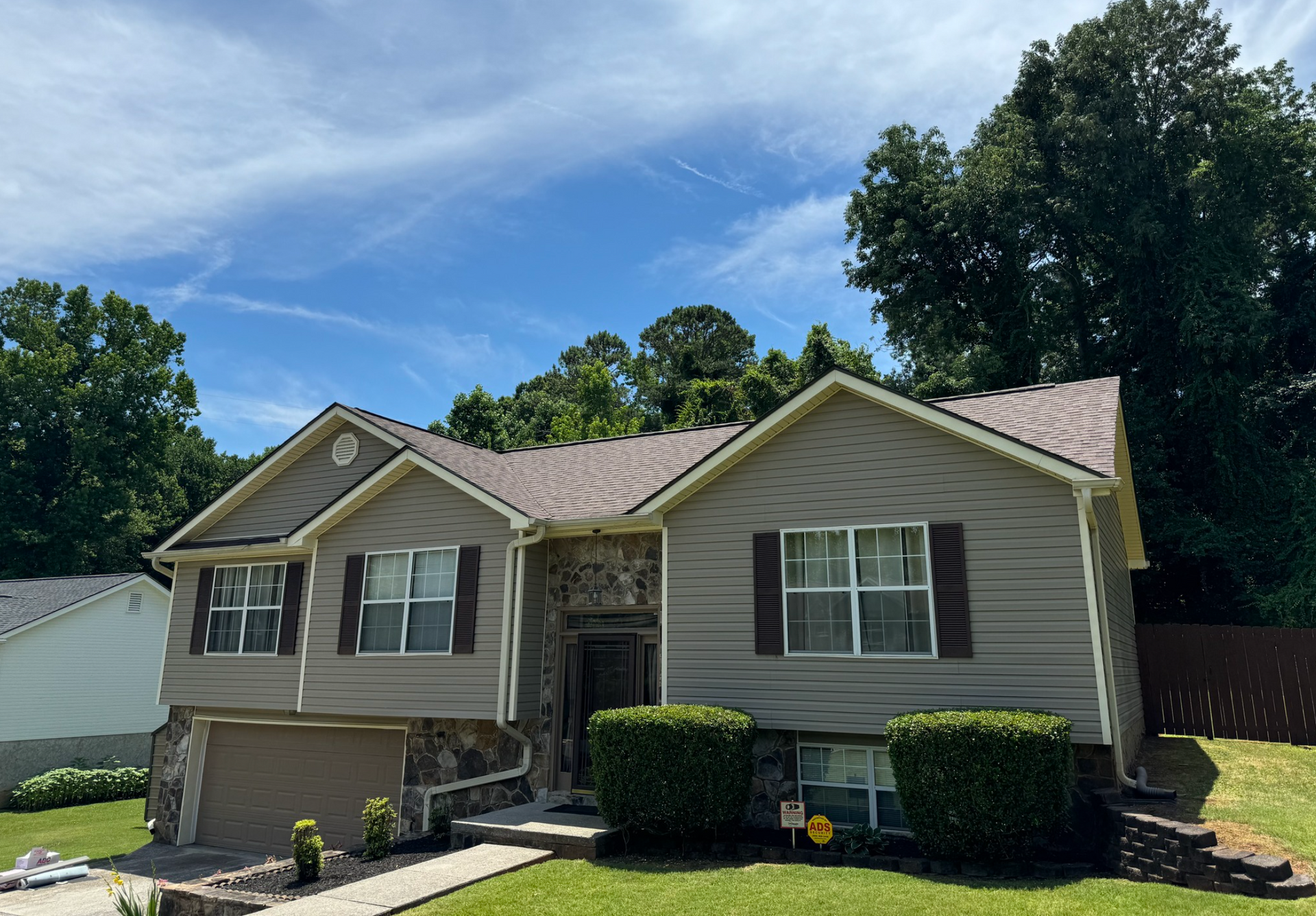 A large house with a lot of windows and a roof