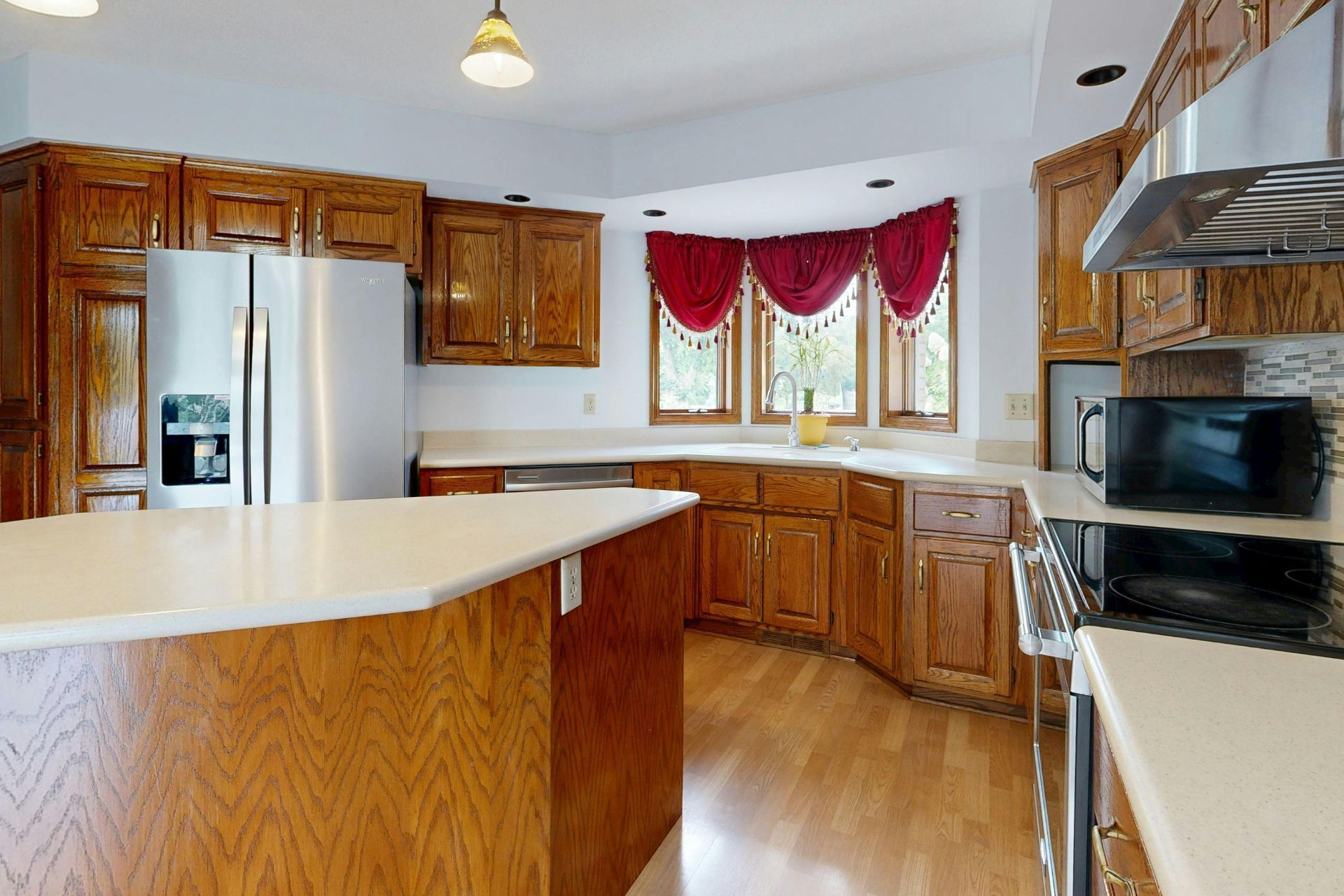 Gray house with a dark roof and white trim under a blue sky.