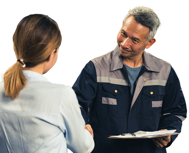 Woman shaking hands with a man in work overalls, smiling, indoors. | King's Auto Center