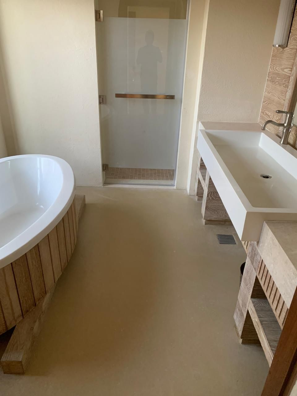 A bathroom with a tub , sink and shower.