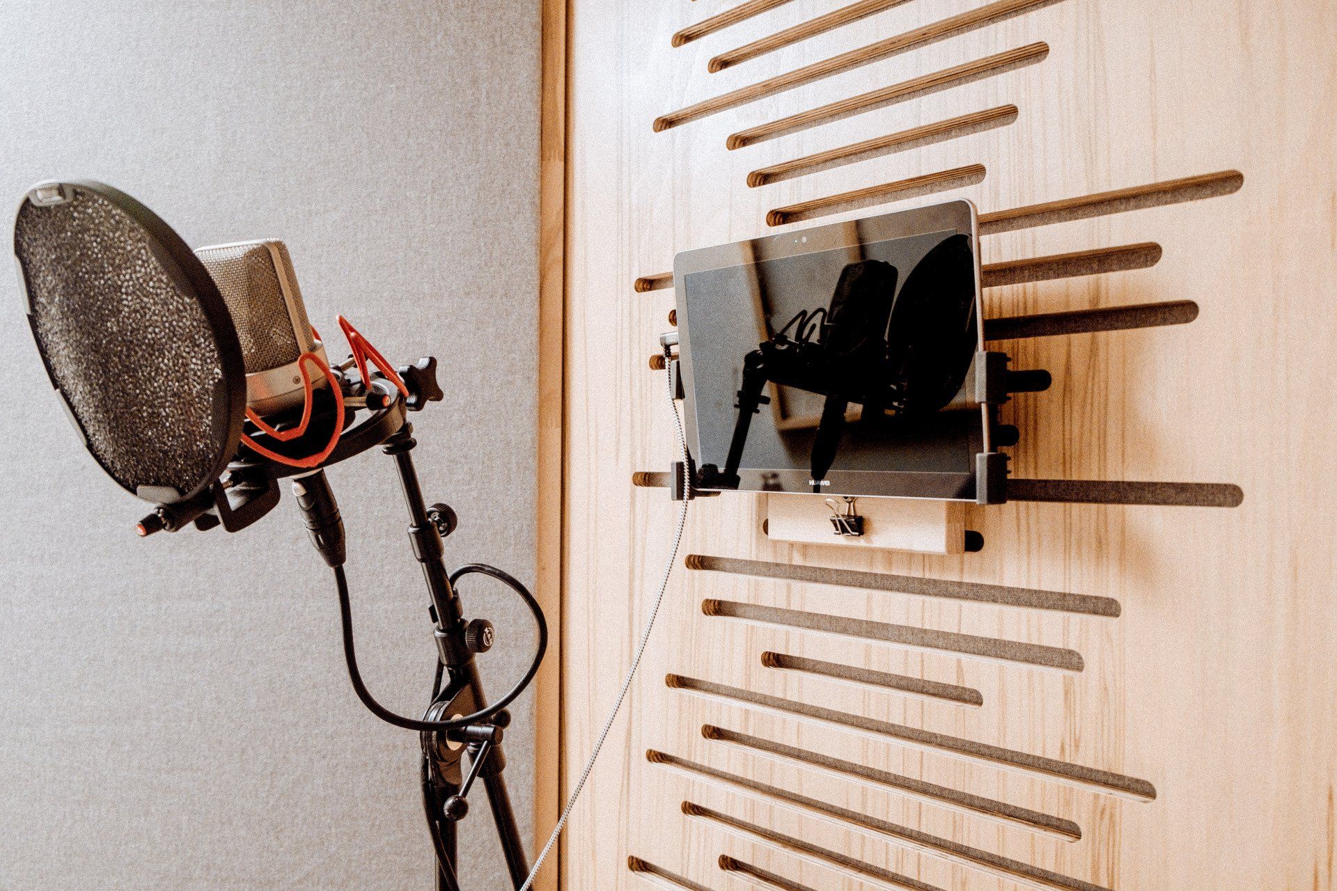 Seitlich aufgenommenes Foto von Mikrofon und Monitor im Studio