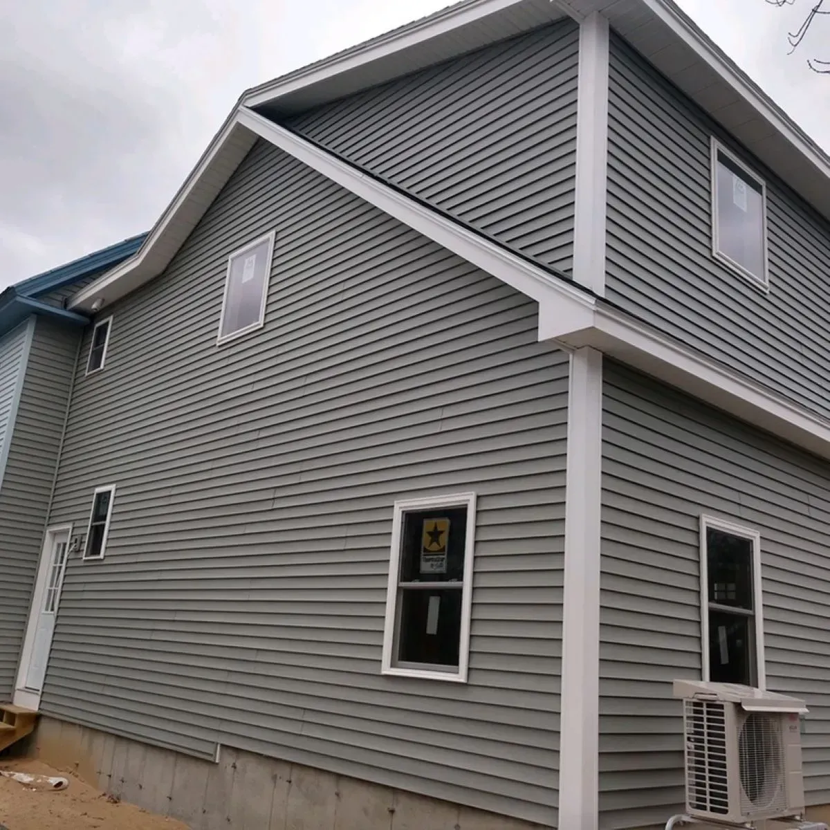 A house with a gray siding and white trim