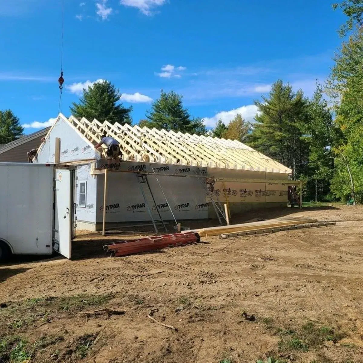 A man is working on the roof of a house.