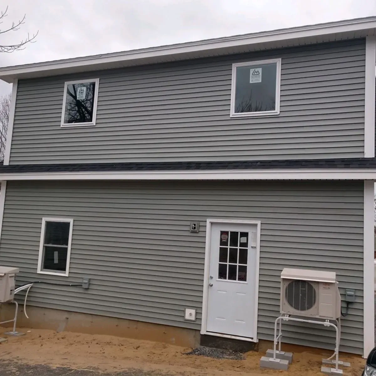 A house with a lot of windows and a white door