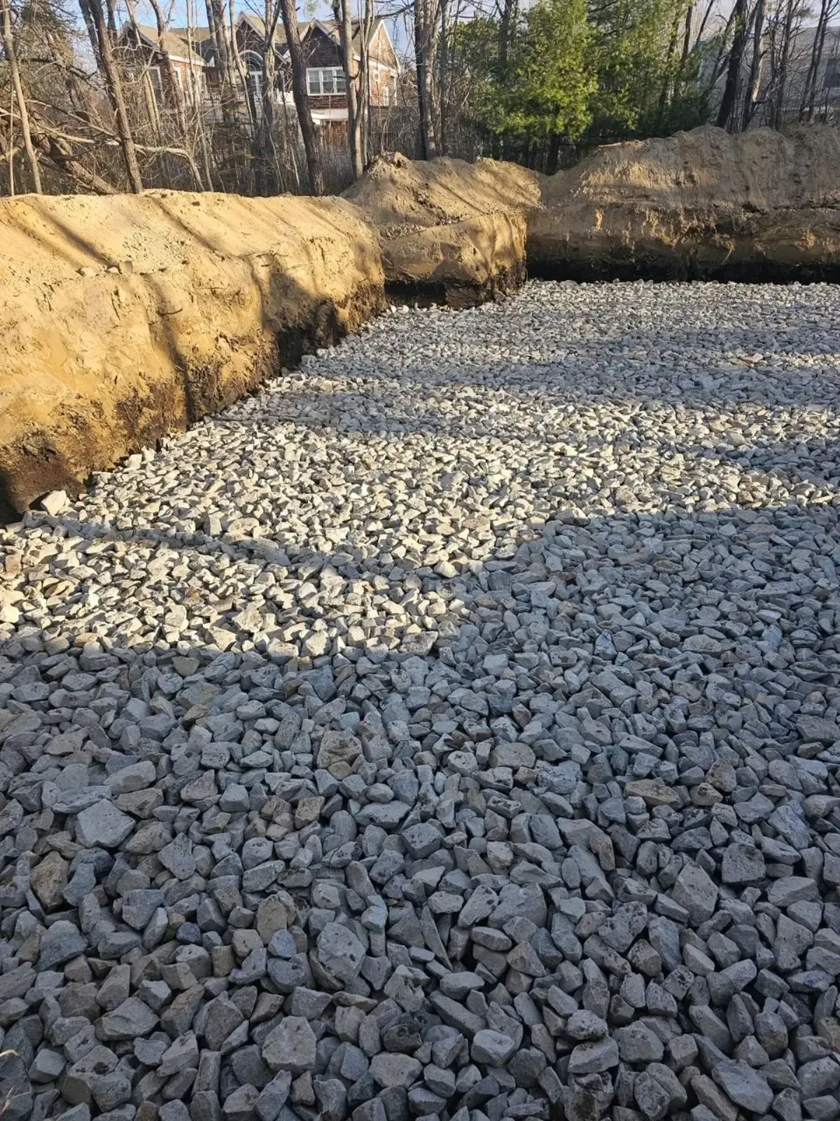 A pile of gravel is sitting on top of a dirt field.