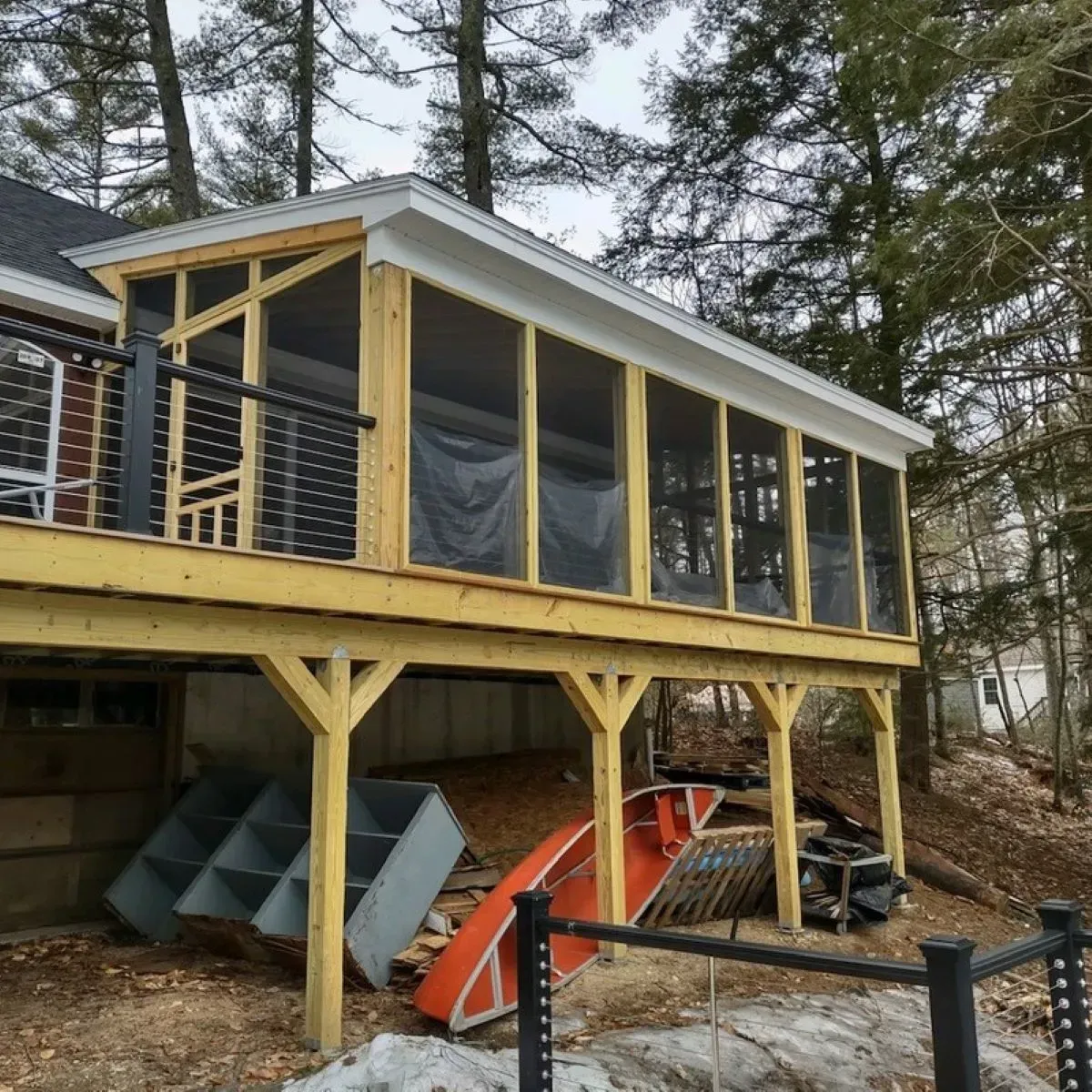 A screened in porch on the side of a house