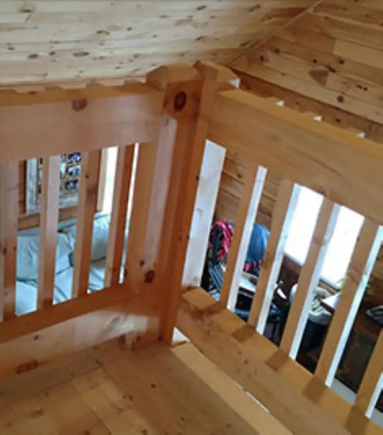 A wooden staircase with a wooden railing and a wooden floor