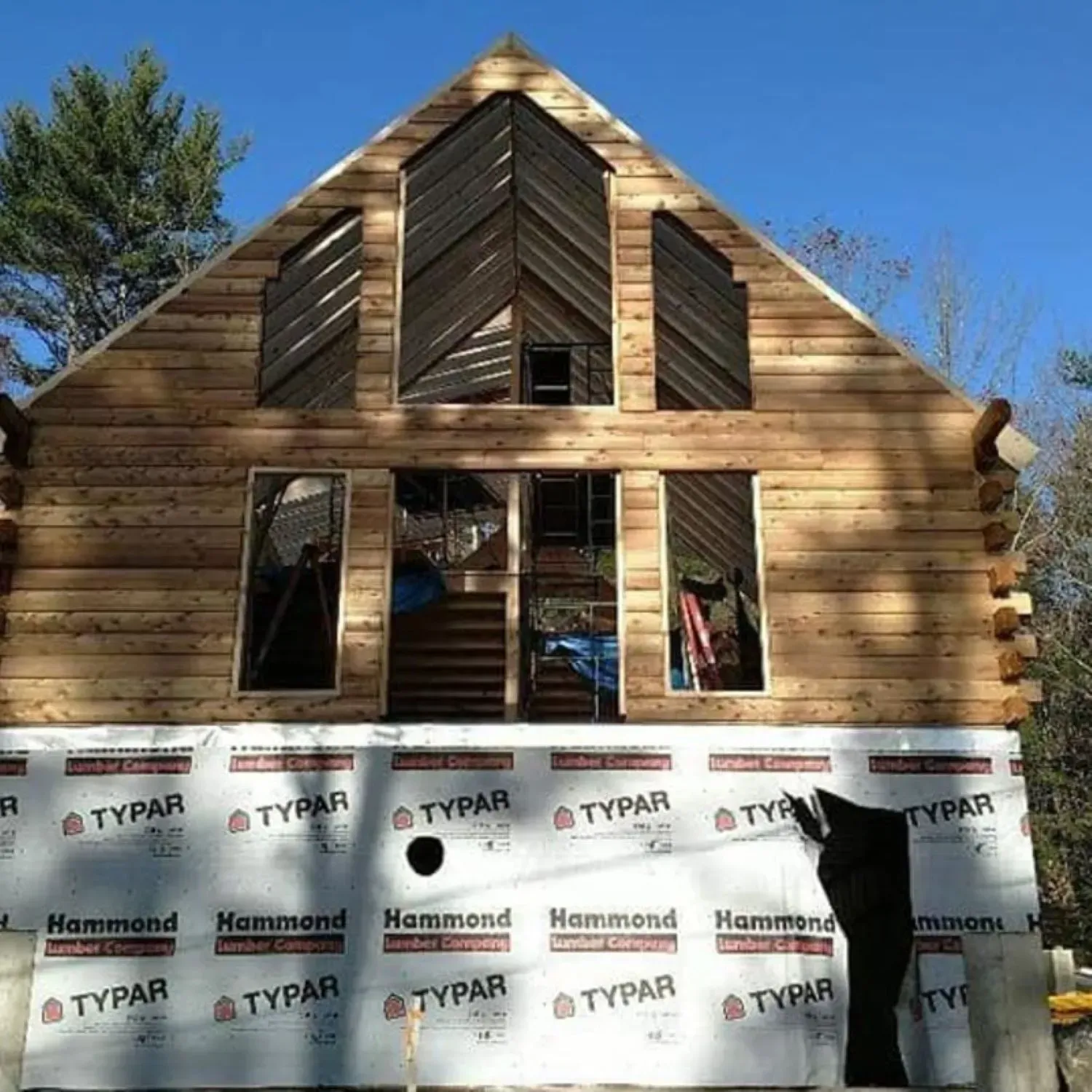 A log cabin is being built with styrofoam from typar