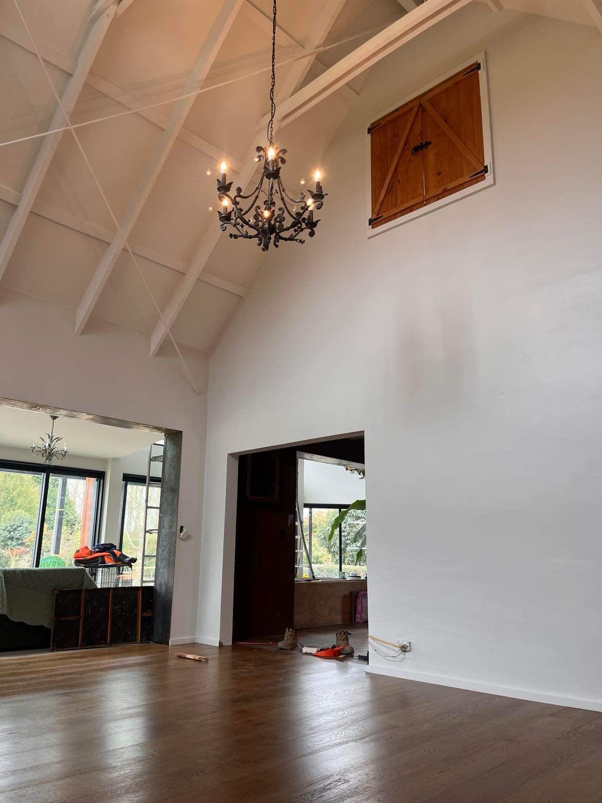 A large empty room with a chandelier hanging from the ceiling.