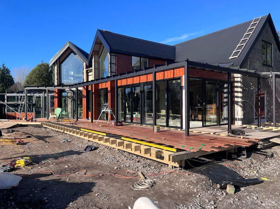 A large house with a lot of windows is being built.