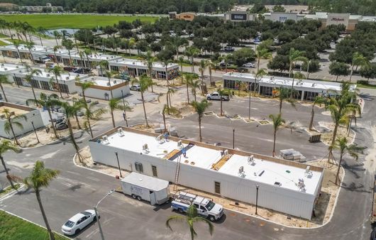 Aerial image of the KRATE shopping plaza roofs after roof replacement by Nations Roofing & Construction