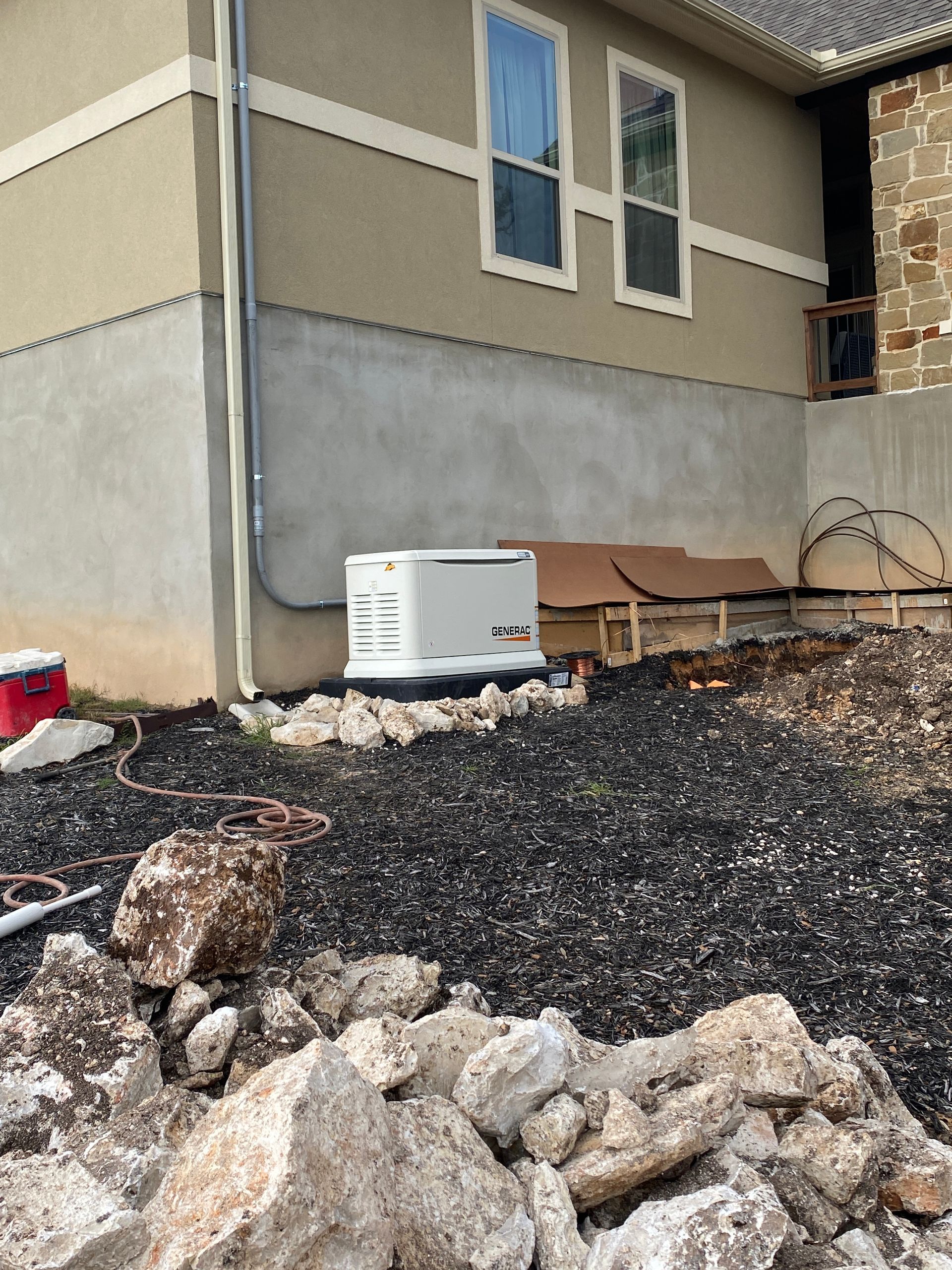 A house with a generator on the side of it