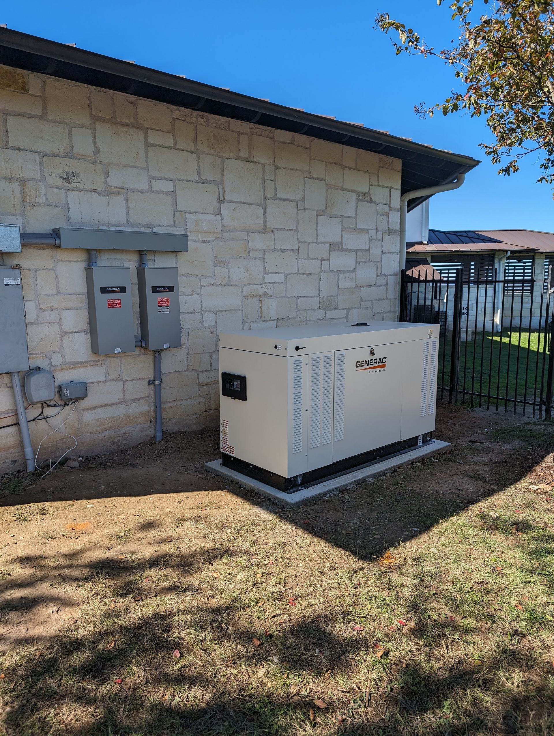 A generator is sitting in the backyard of a house.