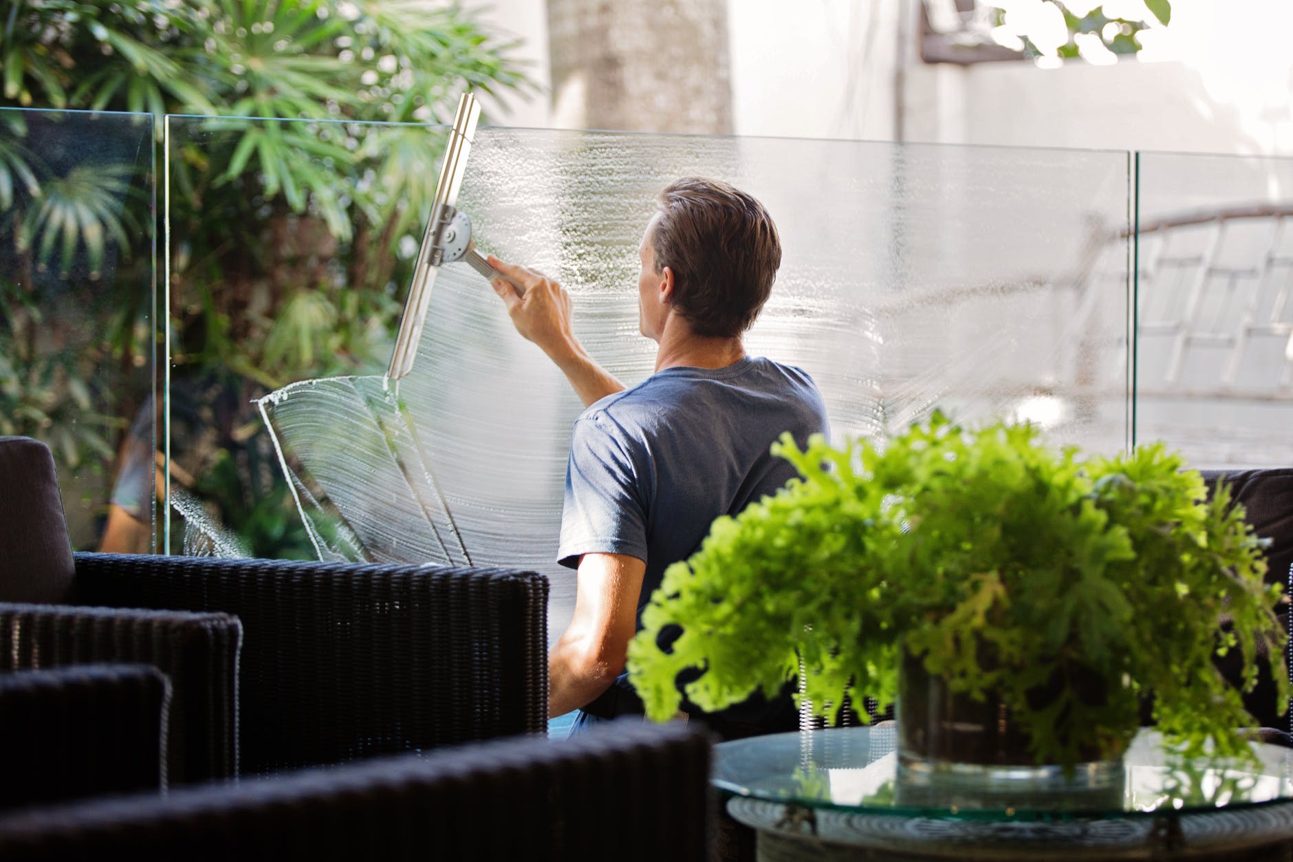 man cleaning glass