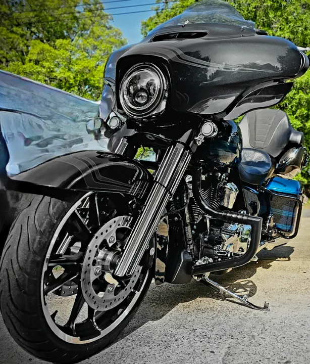 Black Harley-Davidson motorcycle with chrome accents parked outdoors.
