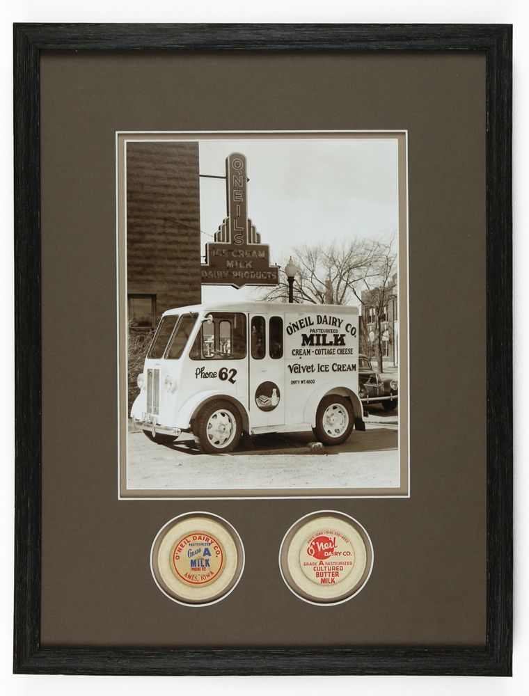 A camera is sitting on a tripod and taking a picture of a building at night.