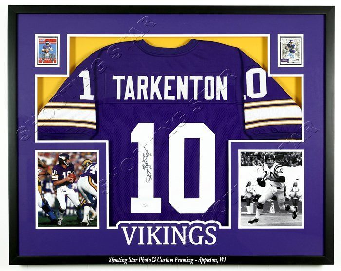 A large dining room with a long table and chairs and paintings on the wall.