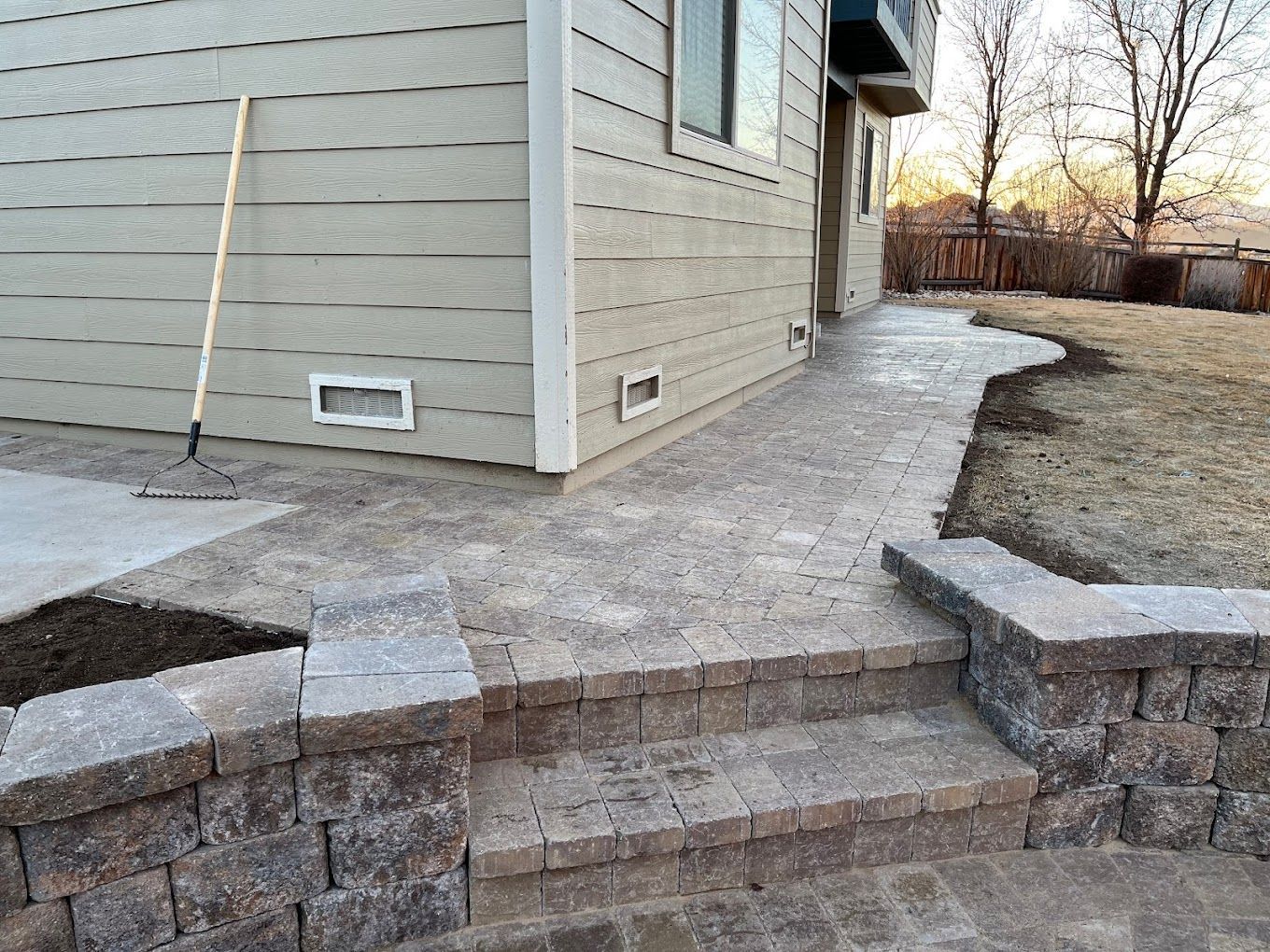 A house with a walkway and stairs leading up to it.
